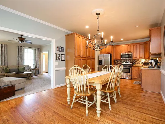 Dining area opening to a warm wood kitchen and adjoining living room