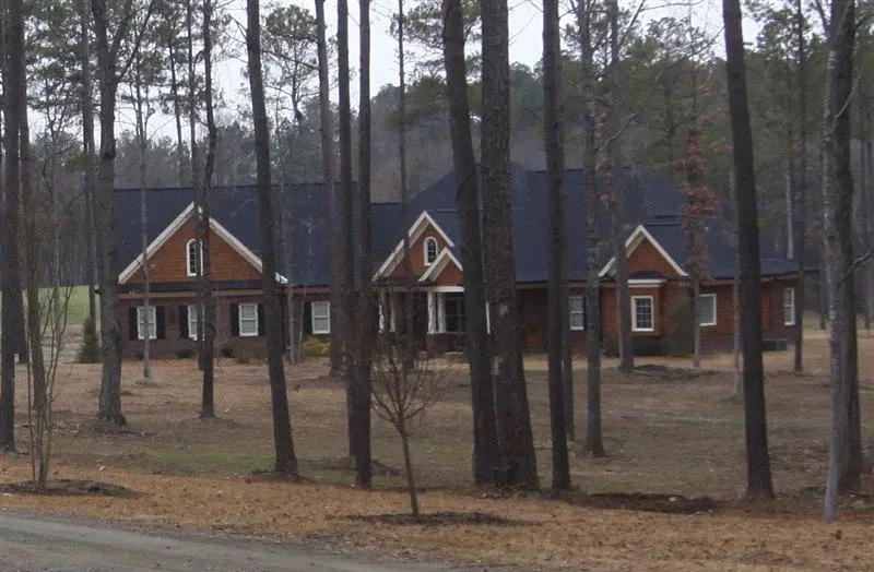 Custom home set among mature trees with a broad lawn