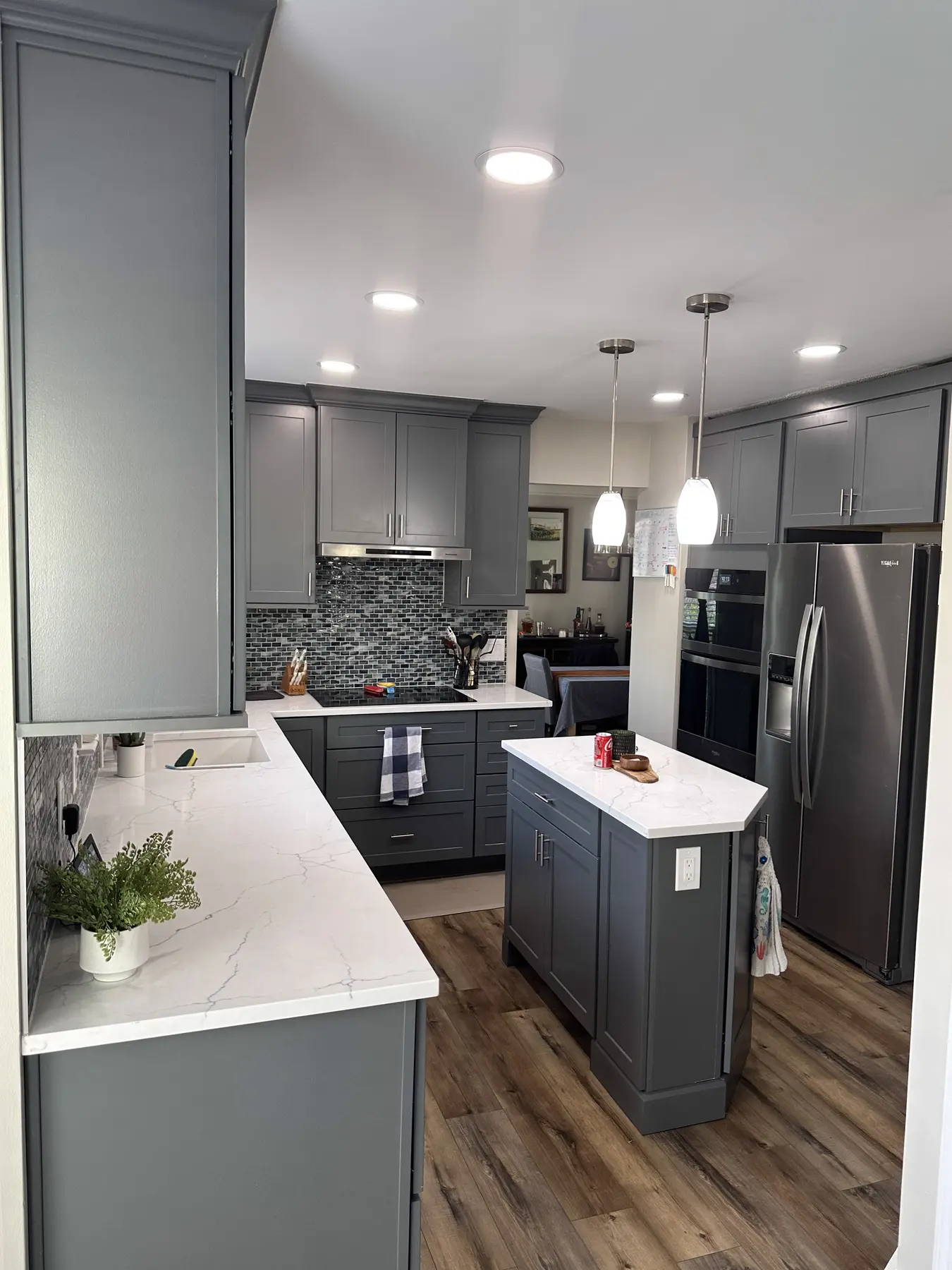 Renovated kitchen with gray shaker cabinetry and a compact island