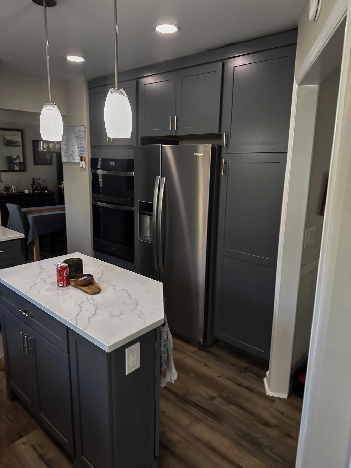 Compact kitchen island beside integrated refrigerator cabinetry