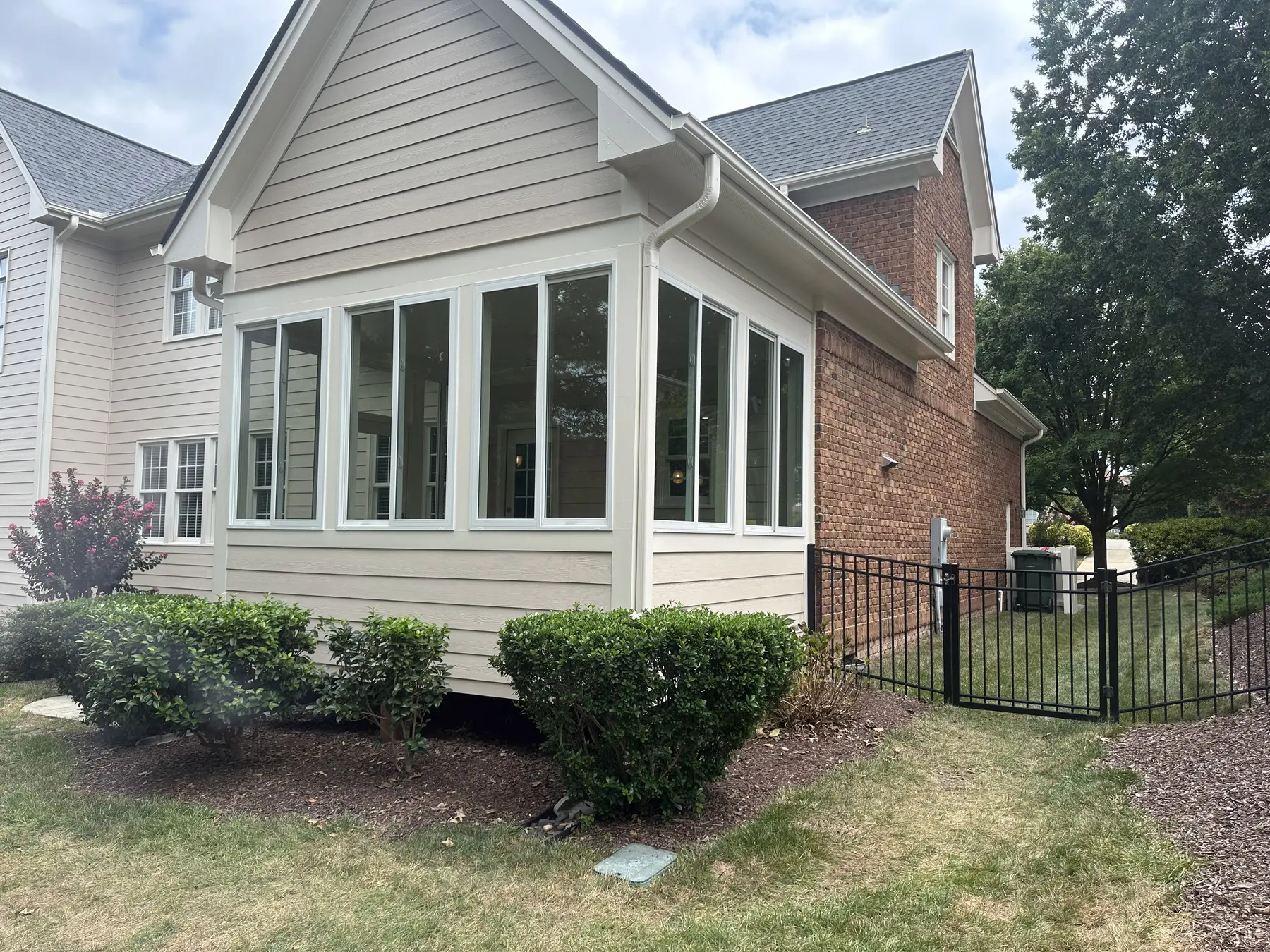 Finished four-season room addition with windows on three sides